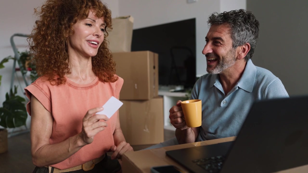 Couple Shopping Online Together in Their New Home