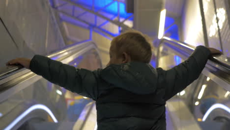 child getting upstairs on escalator