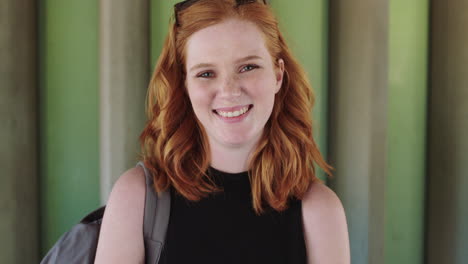 smiling confident red head student portrait of beautiful young woman