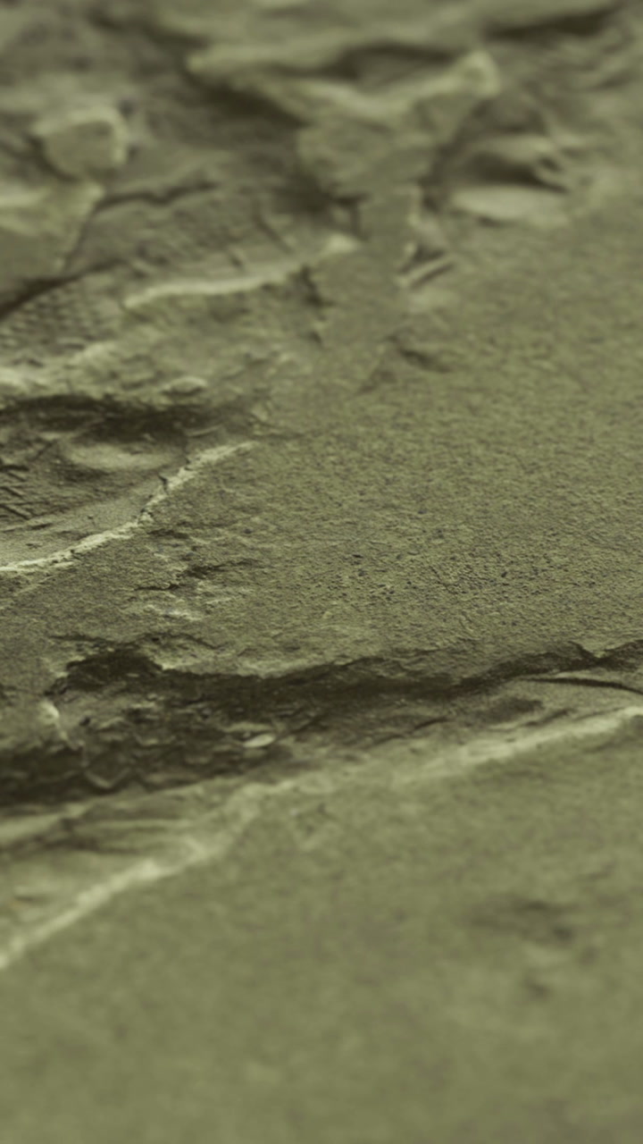 Cracks and texture on a concrete surface seen in a close up view