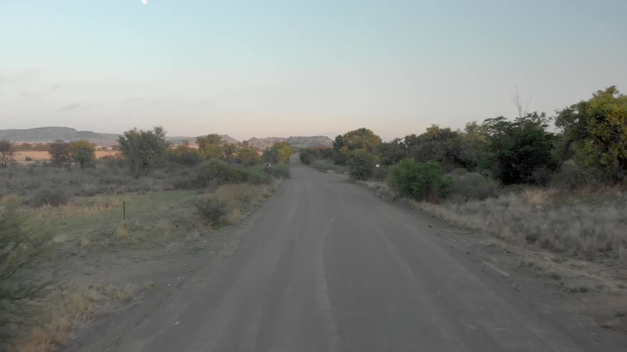 aerial following a gravel road early morning