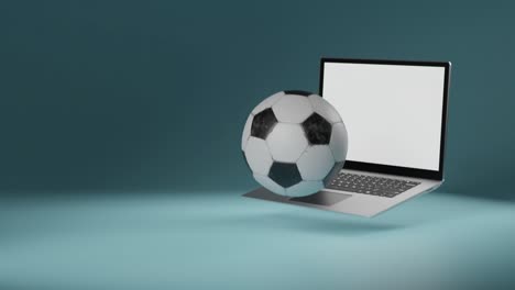 el fútbol frente a la computadora portátil con pantalla blanca cae en el marco