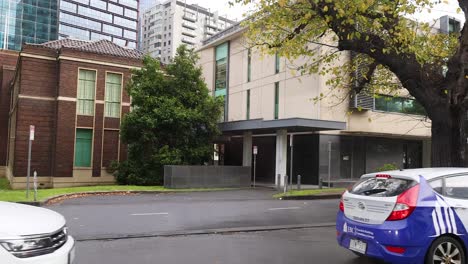 vehicles passing by a city building