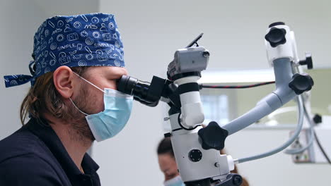 dentist using microscope during procedure