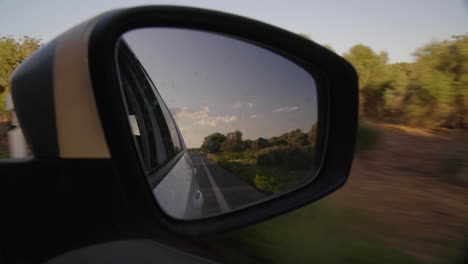 Filming-Car-Passenger-Mirror-while-driving-on-scenic-route-in-the-sunset-on-vacation-Mallorca-Spain-Roadtrip-Freedome