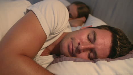 Couple-Sleeping-Peacefully-In-Bed-Together