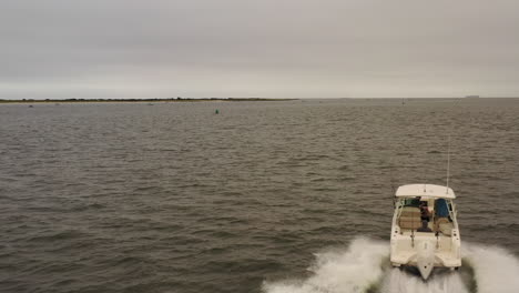 An-aerial-view-of-a-fishing-boat-speeding-out-in-the-Atlantic-Ocean-near-Long-Island,-NY