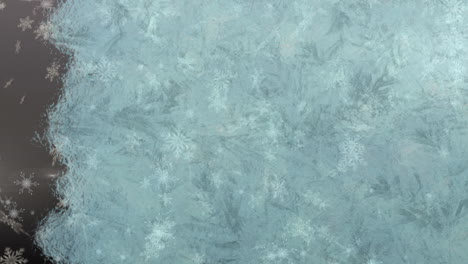 digital animation of background freezing against snowflakes falling against grey background