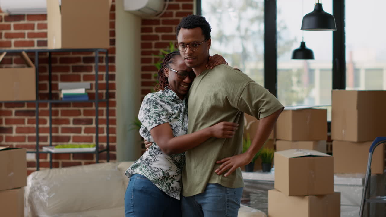 African american couple sharing hug together after decorating