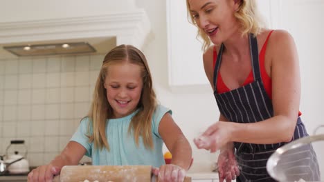Caucasian-mother-and-daughter-baking-together-in-the-kitchen-at-home