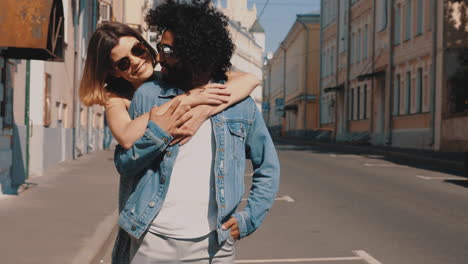 couple hugging on city street