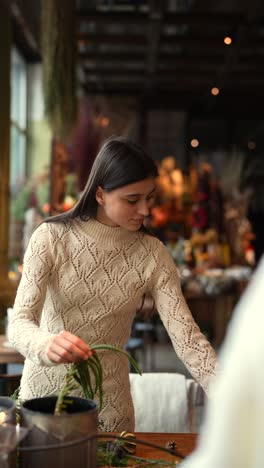 woman crafting christmas decorations in a flower shop