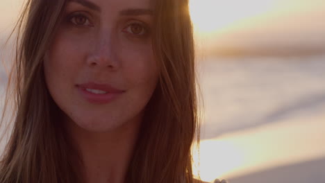 Portrait-beautiful-young-woman-smiling-at-sunset-on-beach-brazilian-lady-enjoying-lifestyle