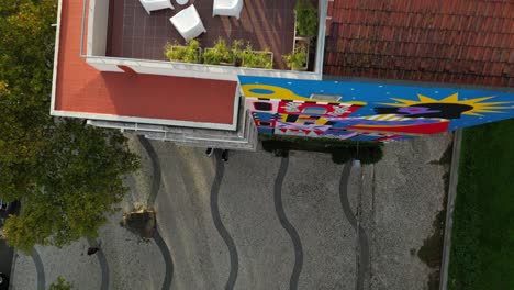 Aerial-shot-of-balcony-with-white-chairs-and-coffee-table-at-top-of-the-building