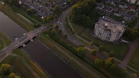 aerial view of a residential area with canal and road at golden hour