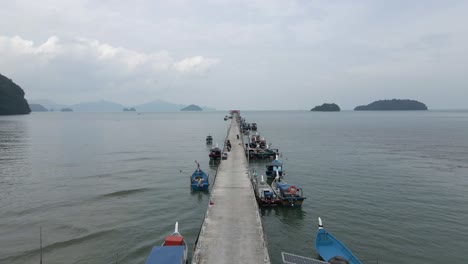 low pov flight along floating pier of moored boats in malaysian sea