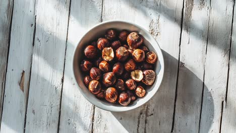 Bowl-of-Hazelnuts-on-Rustic-Wooden-Table-Surface