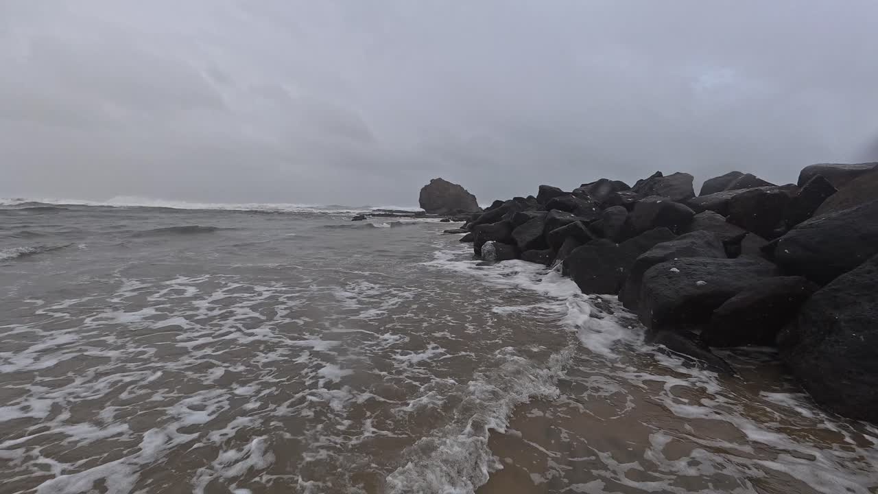 Waves Splashing On Rocks At Currumbin Beach. Cyclone Alfred In Gold Coast, Queensland. panning shot