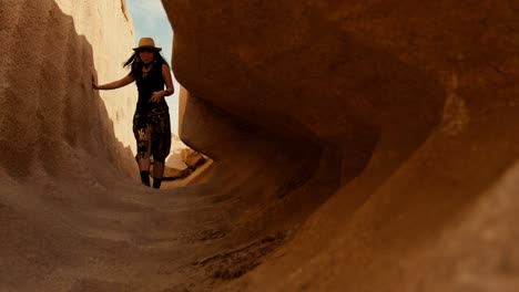 Female-Asian-woman-tourist-walking-to-the-unfinished-obelisk-in-the-northern-region-of-the-stone-quarries-of-ancient-Egypt-in-Aswan