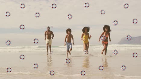 la animación de la vida flota sobre los felices padres y hijos afroamericanos corriendo del mar a la playa.