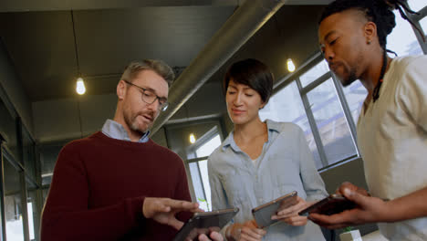 Business-people-discussing-over-digital-tablet-in-office-4k