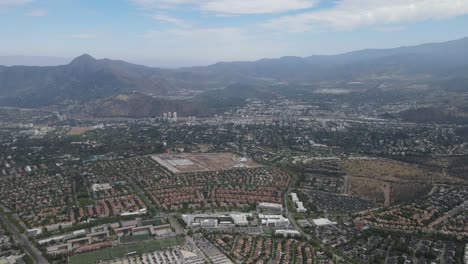 urban santiago cityscape with cerro san cristobal hill showing stadium, buildings and mountains in the background
