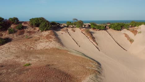 Aerial:-Sand-and-waterslides-in-the-dunes-of-Cumbuco,-Brazil