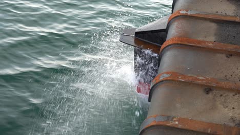 Bow-and-ships-hull-moving-fast-forward-through-ocean-and-penetrating-through-water-surface---Closeup-of-ships-bow-with-water-splashing-around