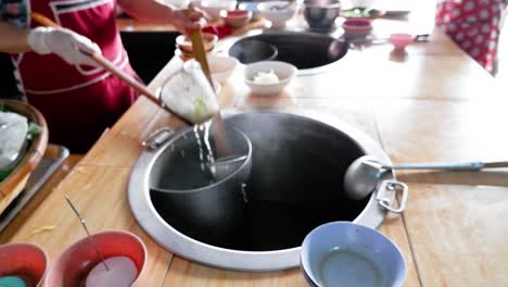 cooking and serving noodles at a food stall