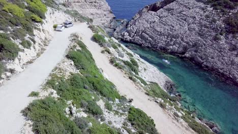 drone footage of small road and parked cars near korakonissi inlet zakynthos greece