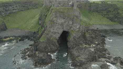 Mermaid's-Cave-Below-Dunluce-Castle,-County-Antrim,-Northern-Ireland---Aerial