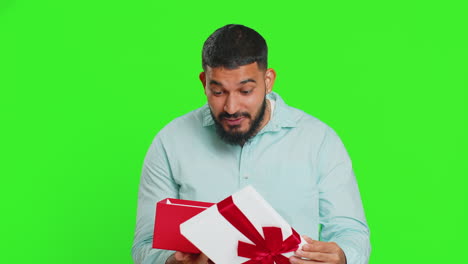 man opening birthday gift box with red ribbon, receiving great present surprise, celebrating