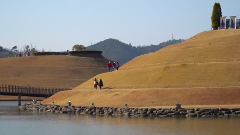 travelers on spiral trails in lake garden of suncheonman bay national garden walking around bonghwa hill with clear sky background