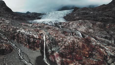 Melting-glacier-with-waterfalls-in-the-Italian-Alps,-aerial-panorama-landscape