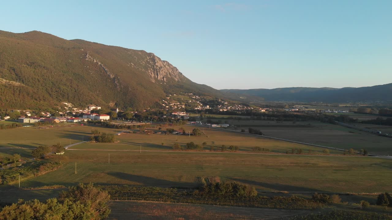 drone descends on vipava valley on summer evening, roads, fields and vineyards of littoral region