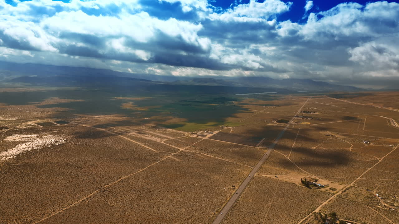 Fantastic cloudscape hanging over the desert and throwing shadows on the land. Beautiful scenery of Nevada desert from aerial view.