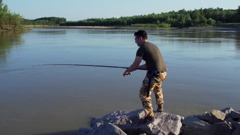 man fishing by the river