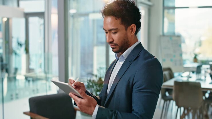 Businessman Using Tablet in Office
