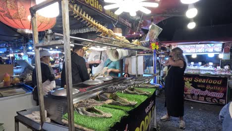 tourists explore crocodile market in krabi, thailand