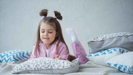 little girl playing on bed