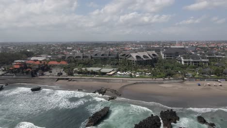 aerial pan across como beach club on waterfront at canggu beach, bali