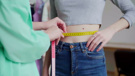 dressmaker taking measurements.