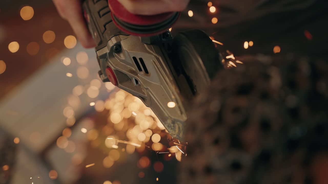tool grinding metal with bright sparks in slow motion close up