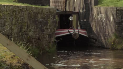 canal barge emerges from lock