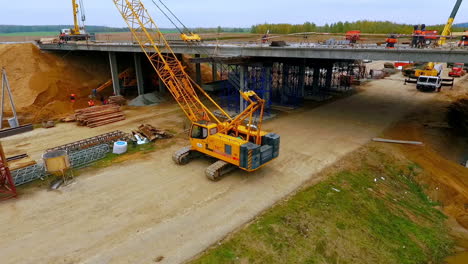 bridge construction. sky view of crawler crane repair bridge over highway road