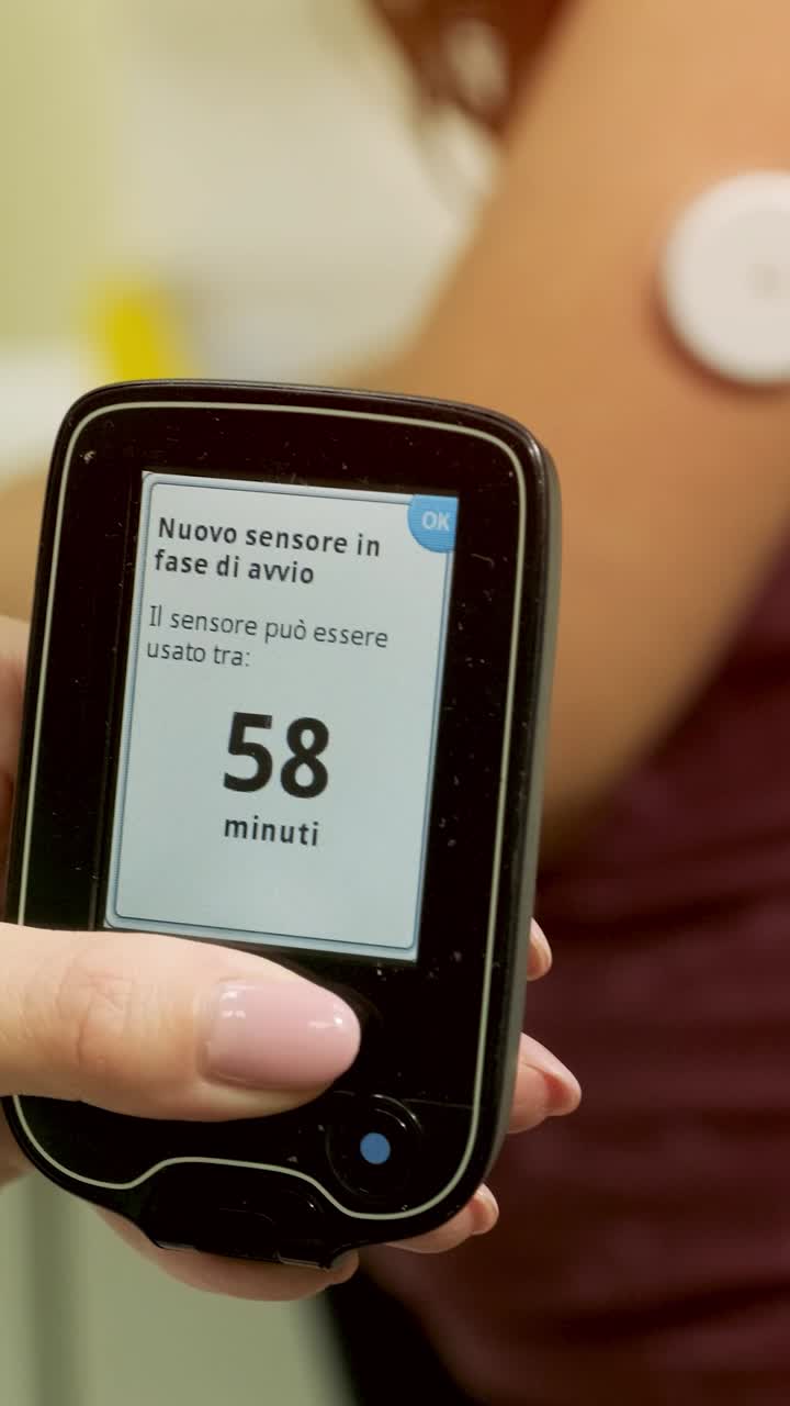 Diabetic Patient Monitoring Blood Glucose with CGM Sensor and Reader