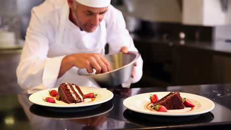 chef putting strawberries onto chocolate cake