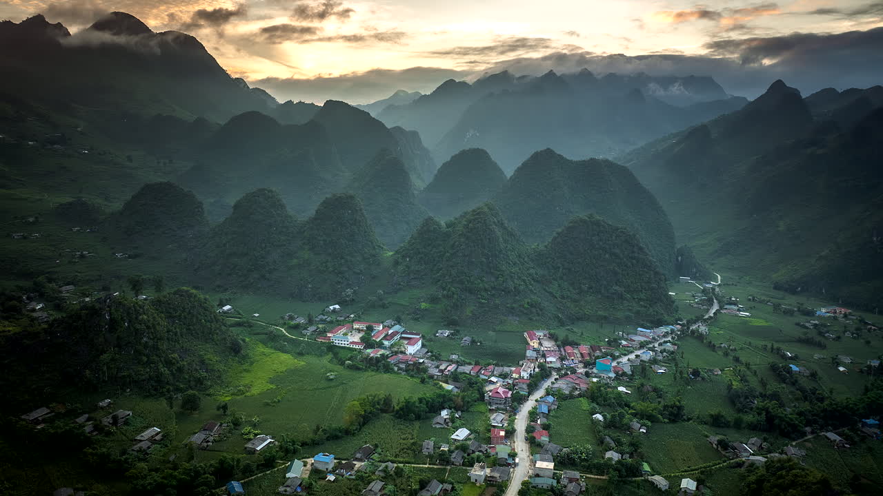 Sunset drone hyperlapse of Lung Ho ethnic minority village in karst landscape