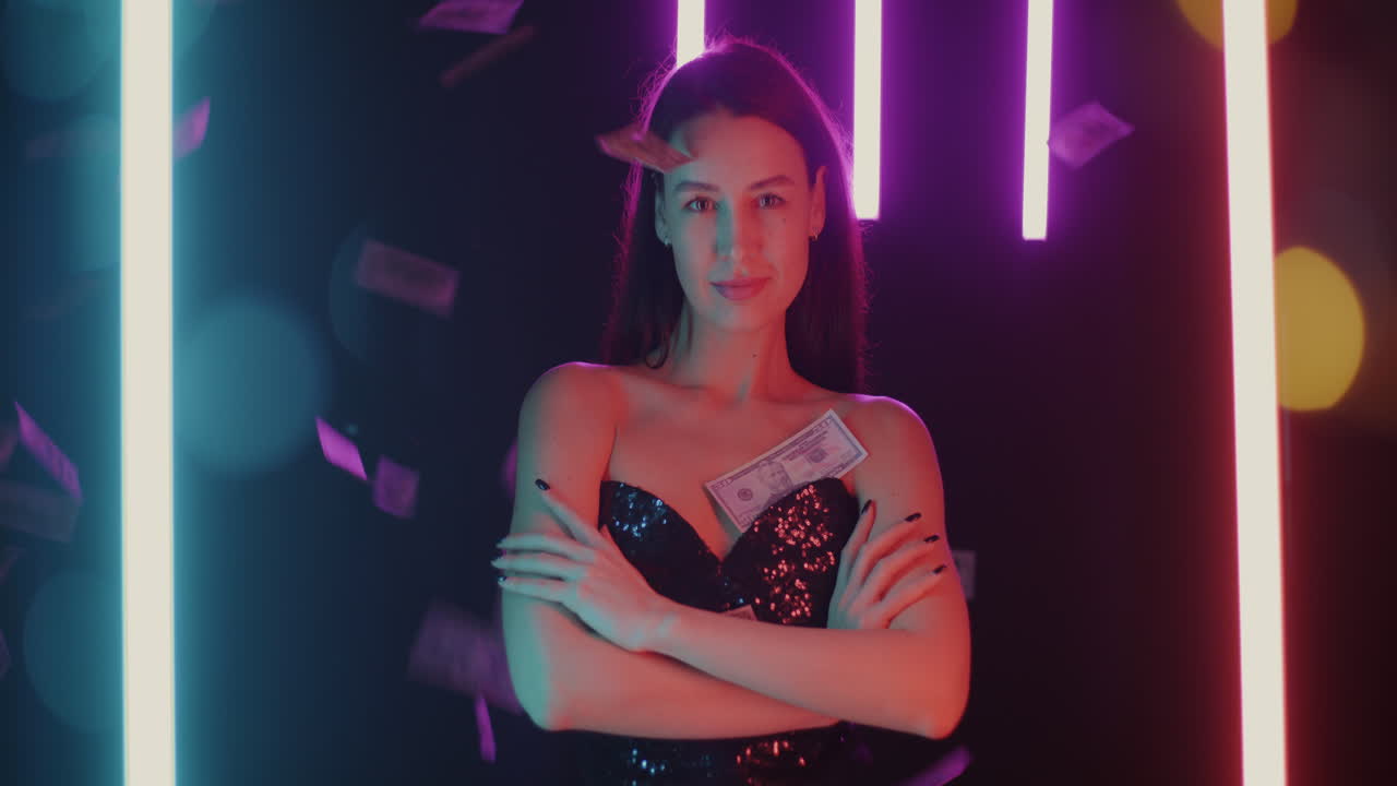 Woman in a sparkling dress posing with neon lights and money