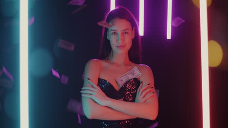 woman in a sparkling dress posing with neon lights and money